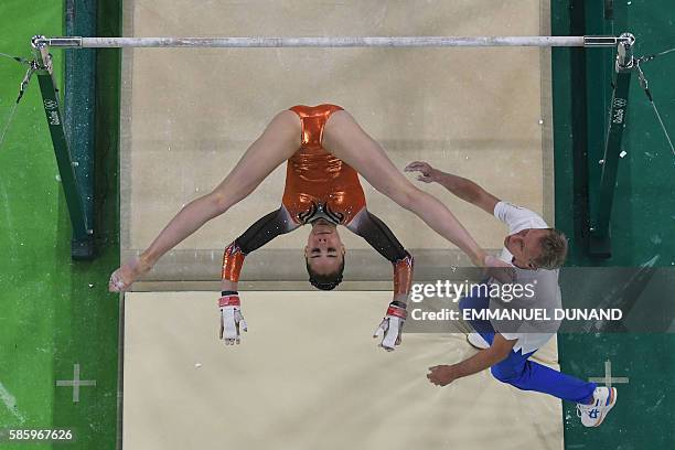 Gymnast takes part in a training session on the uneven bars at the women's Artistic gymnastics at the Olympic Arena on August 4, 2016 ahead of the...