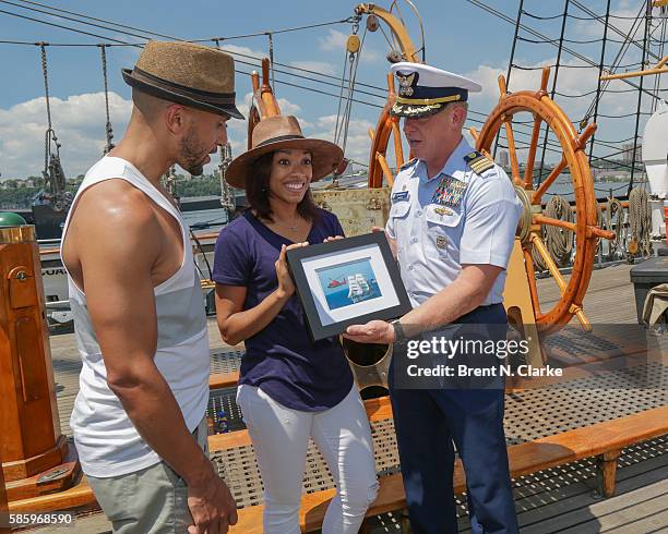 Actor/singer Sydney James Harcourt, actress/singer Kamille Upshaw, both from the cast of Broadway's "Hamilton", recieve a commemorative photograph of...