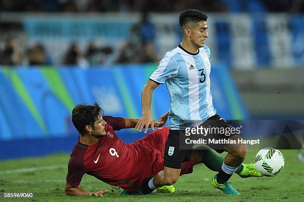 Paciencia Goncalo of Portugal slides into Alexis Soto of Argentina during the Men's Group D first round match between Portugal and Argentina during...