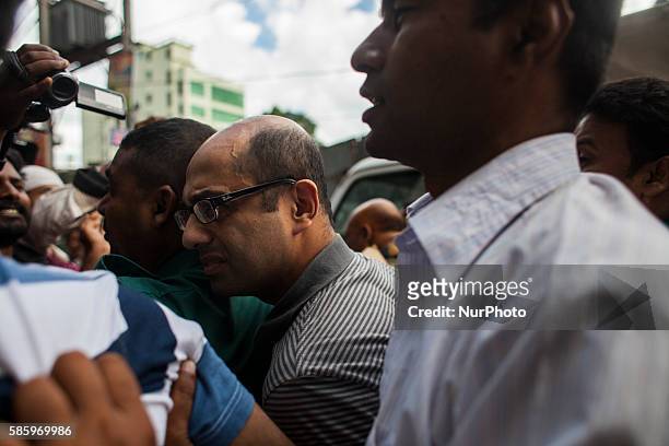 Hasnat Karim, a British citizen of Bangladeshi origin, is surrounded by police officers in Dhaka on August 4, 2016 before appearing in court....