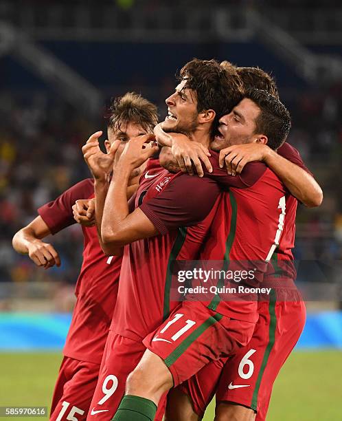 Paciencia Goncalo of Portugal celebrates his goal with his teammates during the Men's Group D first round match between Portugal and Argentina during...