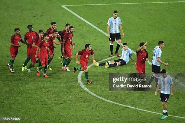 Paciencia Goncalo of Portugal celebrates with his team after scoring during the Men's Group D first round match between Portugal and Argentina during...
