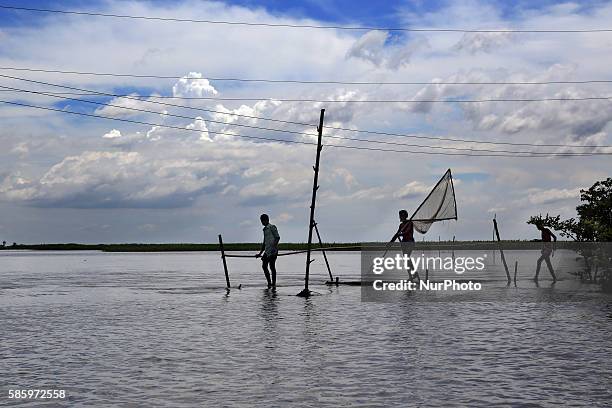 People are going to catch fish in the flood water. Water from Jamuna river came all over the Islampur area and caused flood.