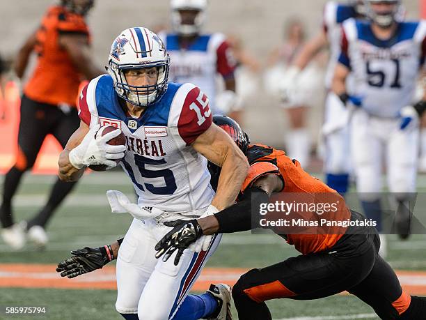 Defensive back Loucheiz Purifoy of the BC Lions prepares to tackle wide receiver Samuel Giguere of the Montreal Alouettes during the CFL game at...