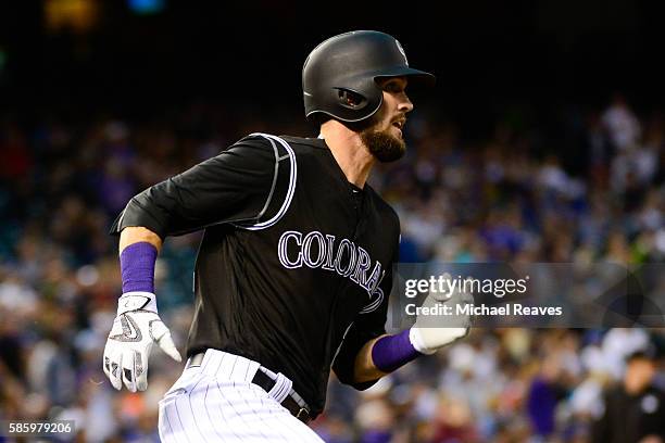 Colorado Rockies outfielder David Dahl rounds first base after hitting a home run in the fourth inning during the game at Coors Field against the Los...