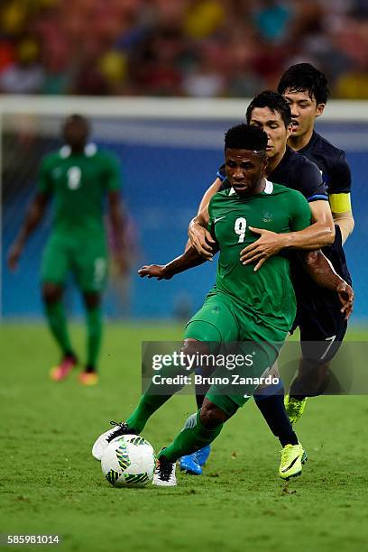 Imoh Ezekiel player of Nigeria battles for the ball with japan players during 2016 Summer Olympics match between Japan and Nigeria at Arena Amazonia...