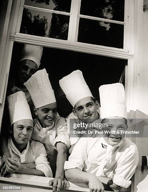 Five young cooks looking out of the window