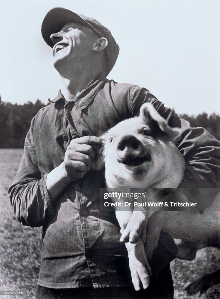 Farmer holding pig