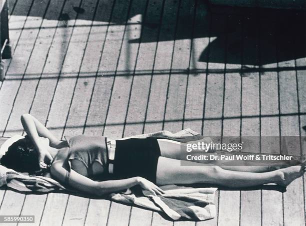 Young woman sunbathing on cruise ship deck