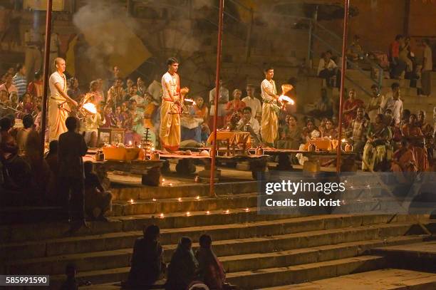 men lighting candles for diwali - bathing ghat stock pictures, royalty-free photos & images