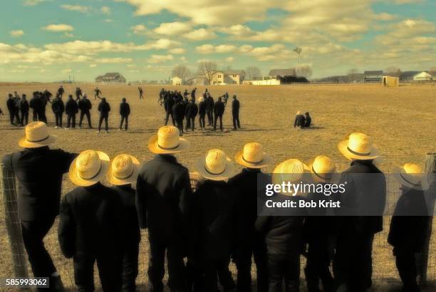 amish children playing touch football - amish straw hat stock pictures, royalty-free photos & images