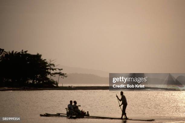 couple riding in bamboo skiff - ポートアントニオ ストックフォトと画像