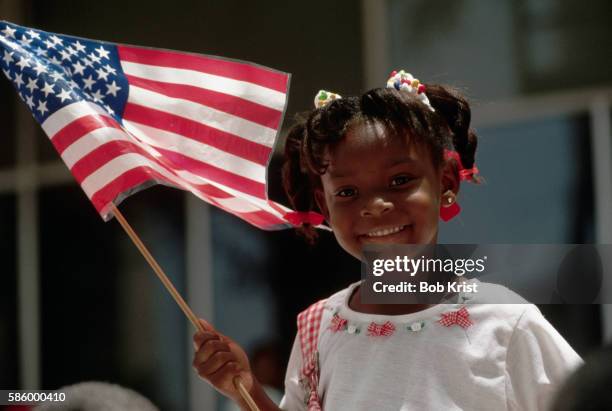 girl holds american flag for fourth of july - peachtree street stock-fotos und bilder
