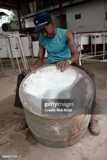 man makes a steel drum in trinidad - tamburo steel drum foto e immagini stock