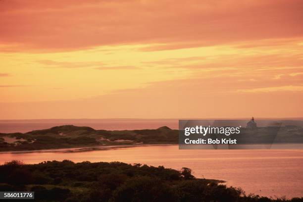 golden sky over block island north lighthouse - block island lighthouse stock pictures, royalty-free photos & images