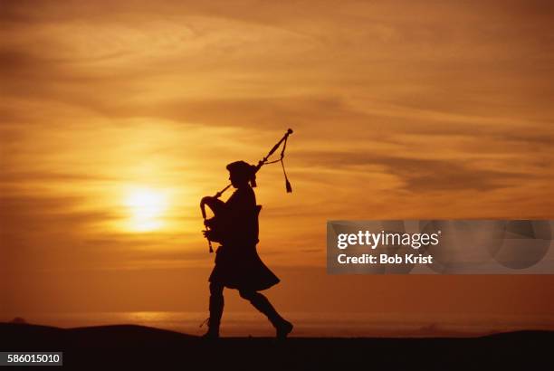 bagpiper playing at sunset - bagpipes stock pictures, royalty-free photos & images