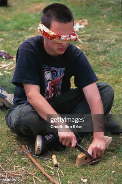 student carving wood while blindfolded - crossed knives stock pictures, royalty-free photos & images