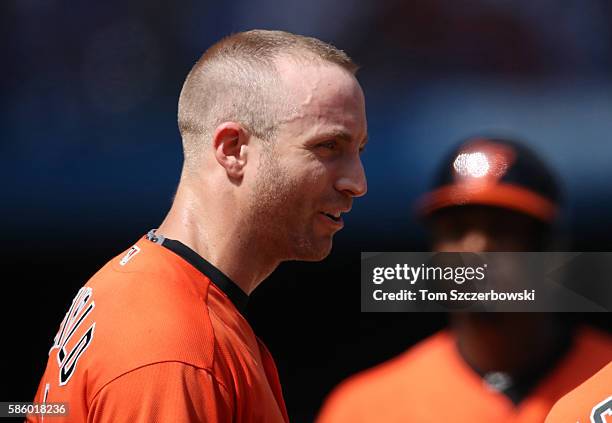 Nolan Reimold of the Baltimore Orioles stands on third base during a break in the action in the eighth inning during MLB game action against the...