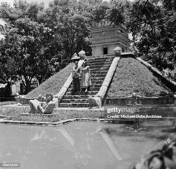 Couple walks down the steps of a Mayan pyramid in La Concordia Park Tegucigalpa, Honduras.