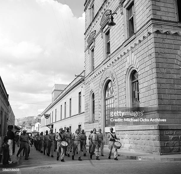 Young military boys march down a city street in Tegucigalpa, Honduras.