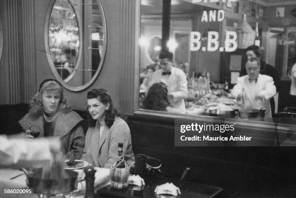 Roberta Cowell , formerly Robert Cowell, at a restaurant, March 1954. Roberta was once a Spitfire pilot, prisoner of war, racing motorist, husband...