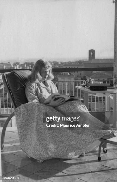 Roberta Cowell , reading a magazine, March 1954. Roberta was once a Spitfire pilot, prisoner of war, racing motorist, husband and father of two, she...