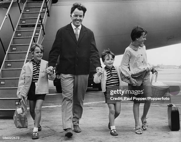 Actor Brian Rix, actor-manager of the Whitehall Theatre, arrives back from a holiday in Spain with his children James, Jonathan and Louisa, at London...