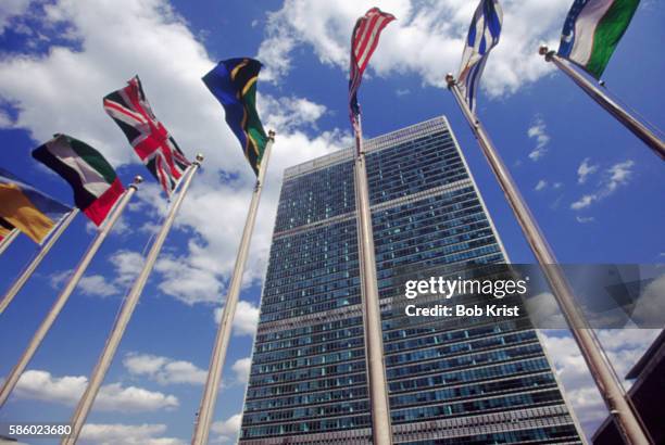 flags outside united nations - diplomacy stock-fotos und bilder