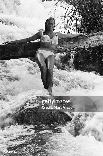 Swiss actress Ursula Andress poses in a rushing stream during the filming of the James Bond movie Dr. No in Jamaica.