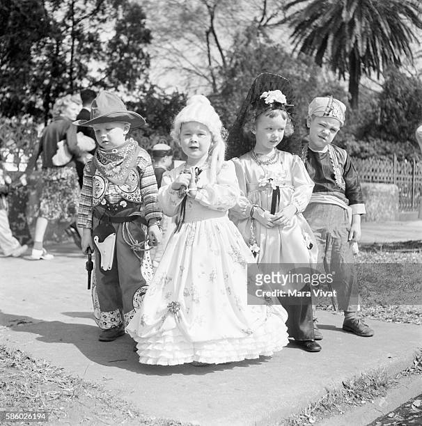 Group of boys and girls dressed up as pirates, cowboys, and princesses for Mardi Gras, New Orleans, Louisiana, circa 1950.