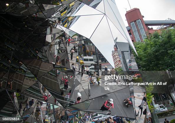 Walking people reflected on glass in tokyu plaza i, Kanto region, Tokyo, Japan Walking people reflected on glass in tokyu plaza i, Kanto region, Tokyo, Japan