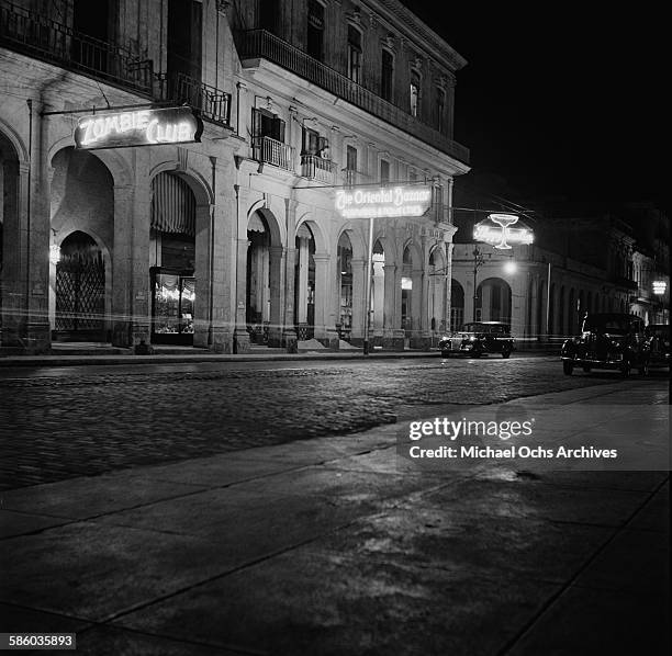 Night street view of the Zombie Club and the Oriental Bazaar bars in Havana, Cuba.