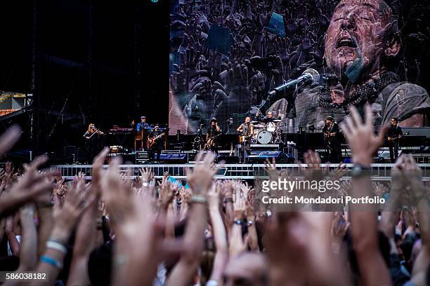 American rock singer Bruce Springsteen in concert at San Siro Stadium. The Boss' face appearing on the monitor behind the musicians. Under the stage,...