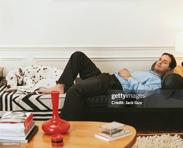 Fashion designer Marc Jacobs is photographed for InStyle Magazine relaxing at home on a chaise longue with his dog in New York City.