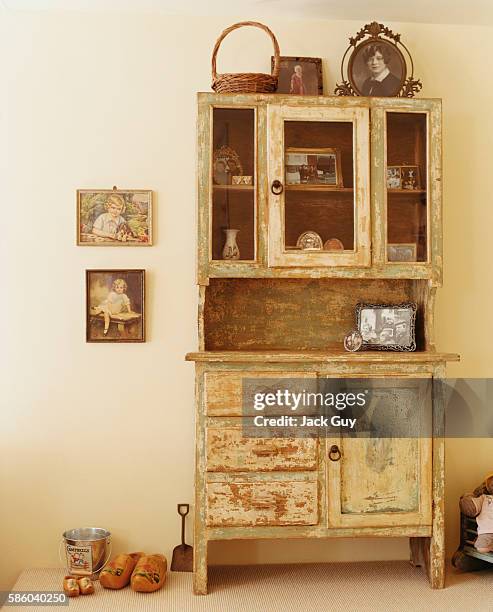 Actress Charlotte Ross's home is photographed for InStyle Magazine in 2002 in Los Angeles, California. Ross's antique china cabinet.