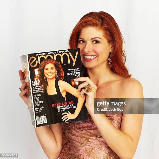 Actress Debra Messing is photographed for Emmy Magazine at the 55th Annual Emmy Awards, holding up a copy of Emmy magazine with a cover shot of...