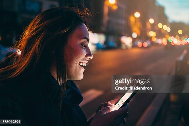 woman texting at night - calling on the side road stock pictures, royalty-free photos & images