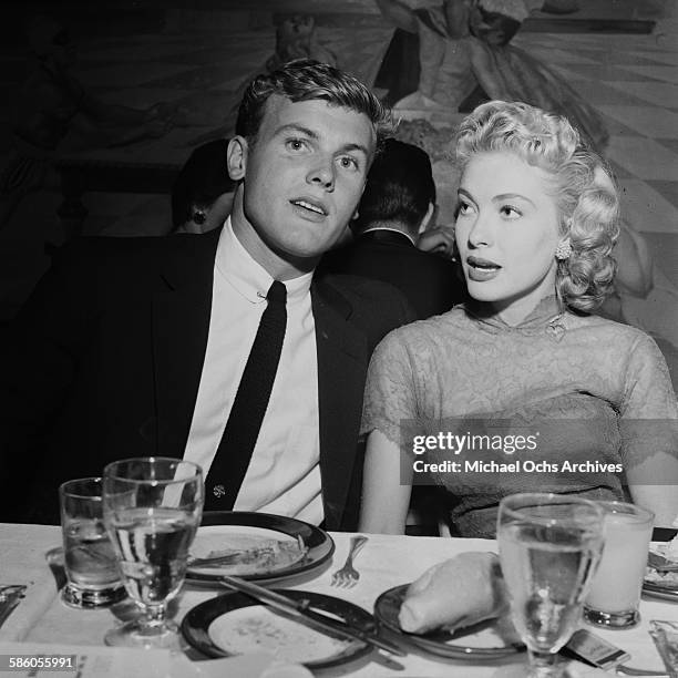 Actor Tab Hunter with Lori Nelson attend a party in Los Angeles, California.