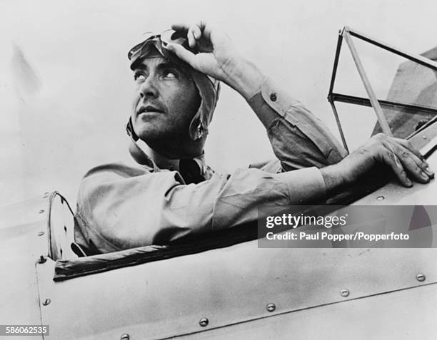 American actor and musician, Charles Buddy Rogers sits in the cockpit of his aircraft as he trains for his wings during World War Two, at the Naval...