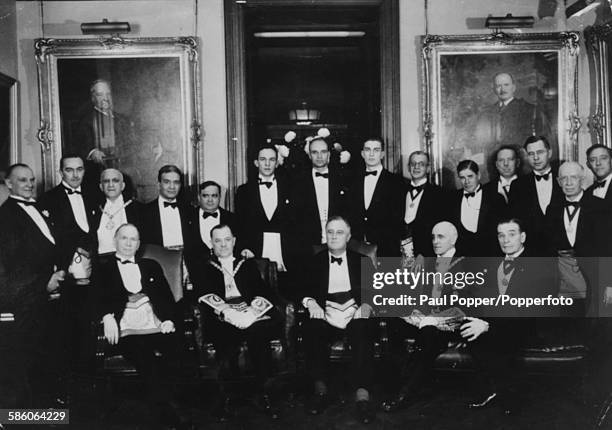 Portrait of President Franklin D Roosevelt with a group of Freemasons wearing full masonic regalia, during the initiation of his sons James and...