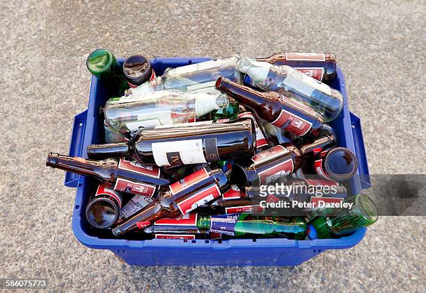 bottle recycling in bin - altglasbehälter stock-fotos und bilder