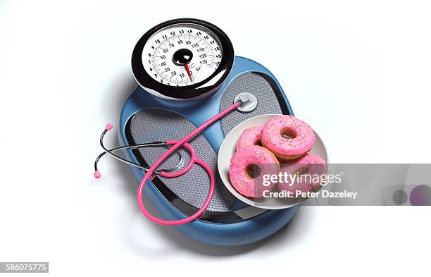 stethoscope and doughnut on scales - blue donut white background stock pictures, royalty-free photos & images