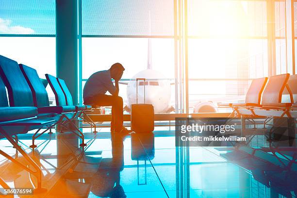 tired airplane passenger wait for plane and covers his eyes - jet lag 個照片及圖片檔
