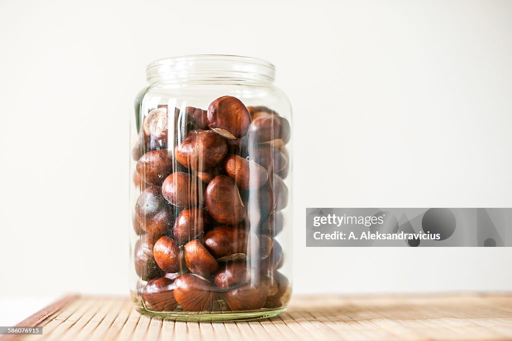 Chestnuts in bowl on wood table