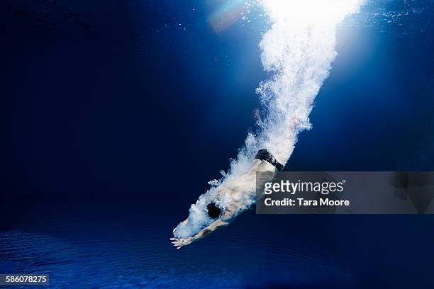 man diving into water - dive stock pictures, royalty-free photos & images