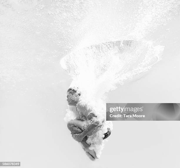 man dive bombing into water - vitality water stock pictures, royalty-free photos & images