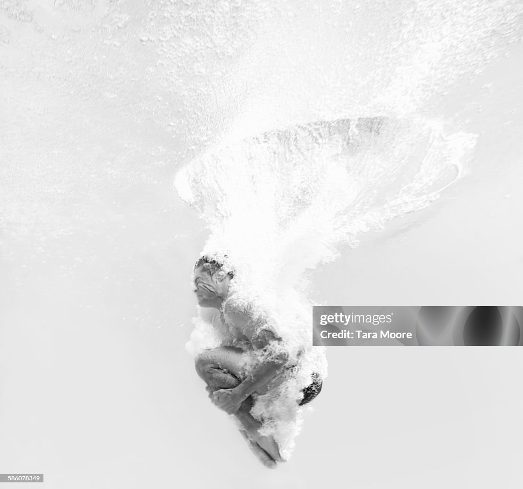 Man dive bombing into water