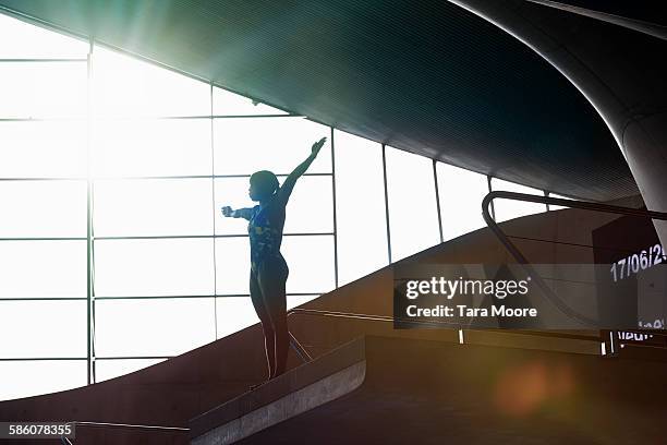 female diver preparing to high dive - diving platform stock pictures, royalty-free photos & images