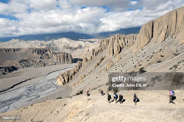 landscape south of dhechyang khola with trekkers - mustang valley stock pictures, royalty-free photos & images