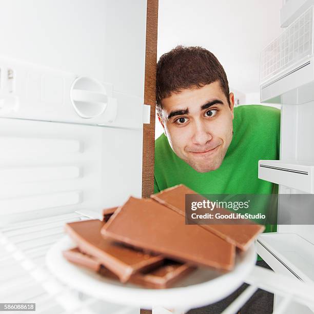 man stealing chocolate - man stealing stock pictures, royalty-free photos & images